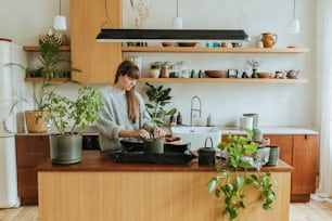 a woman is preparing food in a kitchen