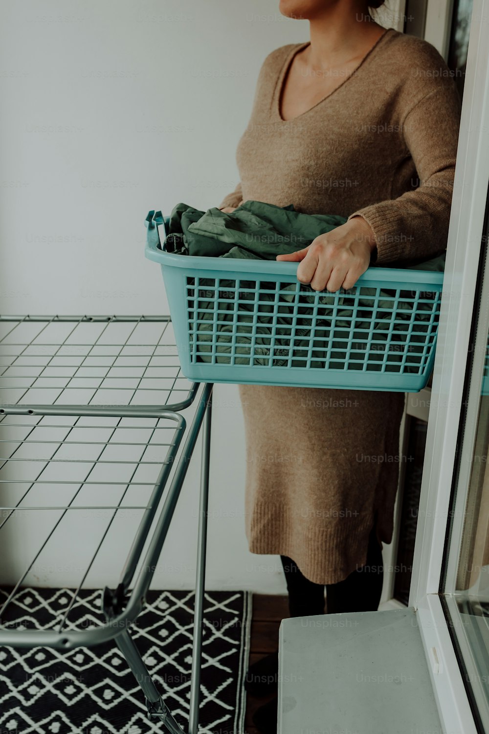 a woman standing next to a laundry basket