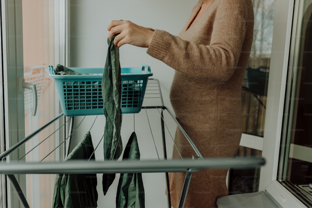 a woman standing in front of a laundry basket