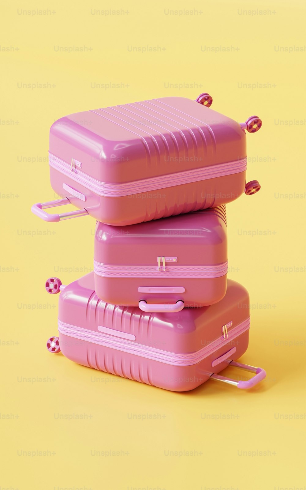 ein paar rosafarbene Koffer, die übereinander sitzen