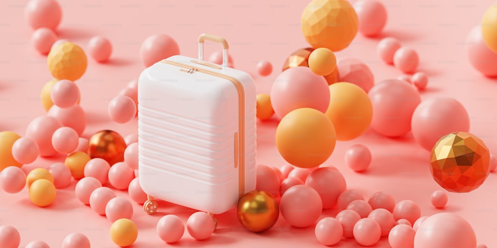 ein weißer Koffer, umgeben von rosa und gelben Kugeln