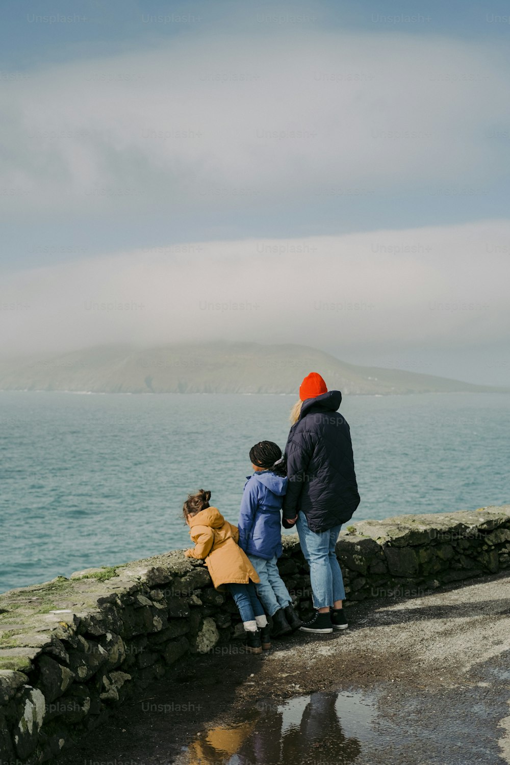 a group of people standing next to a body of water