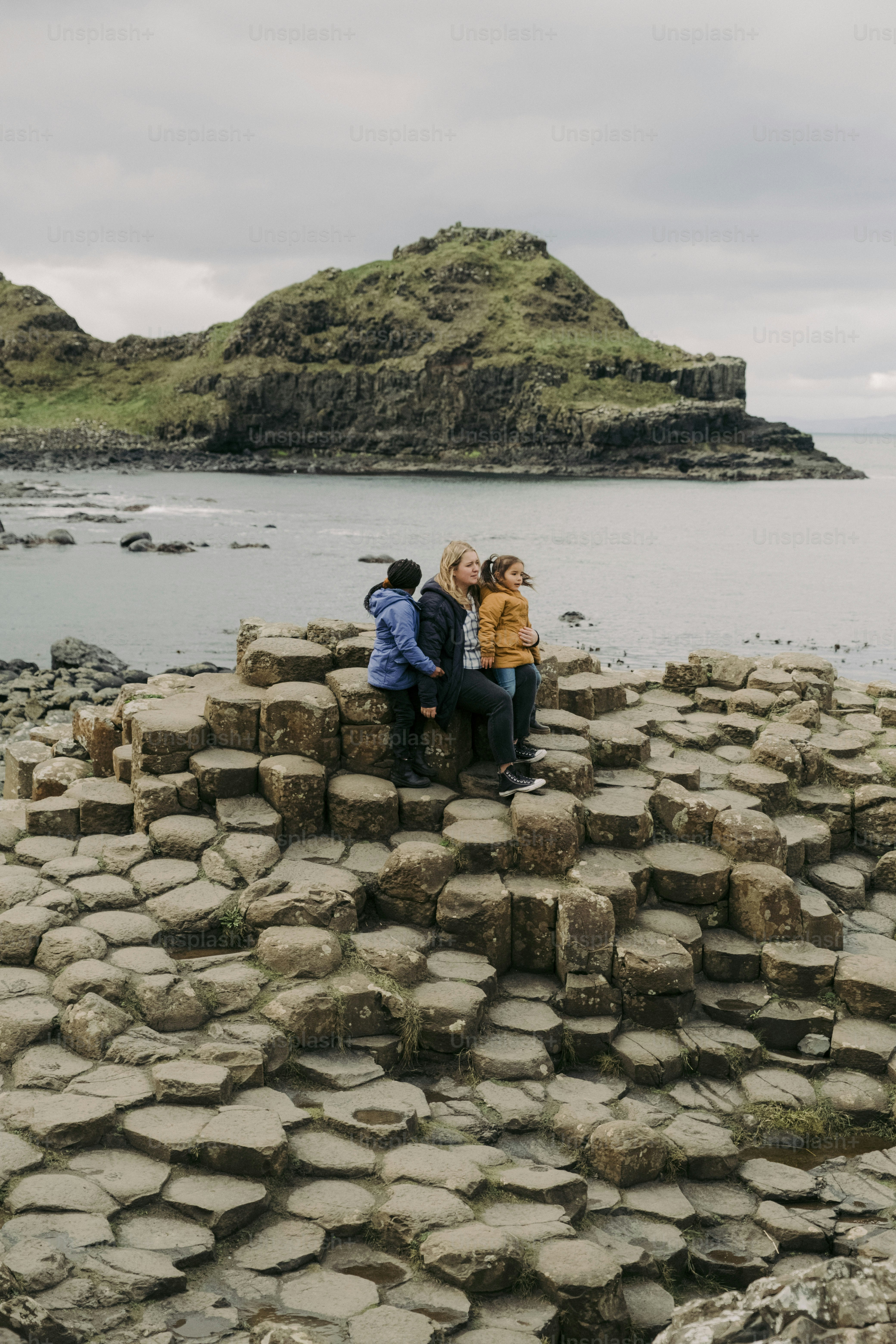 A group of people sitting on top of a rock formation photo – Northern ...