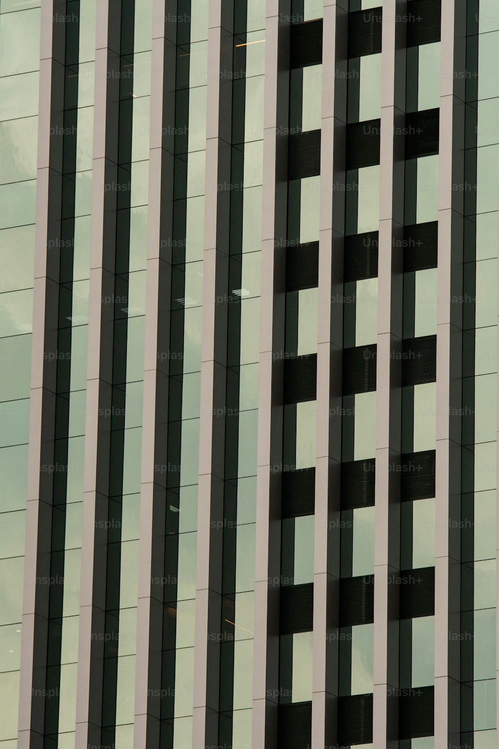 a plane flying in front of a tall building