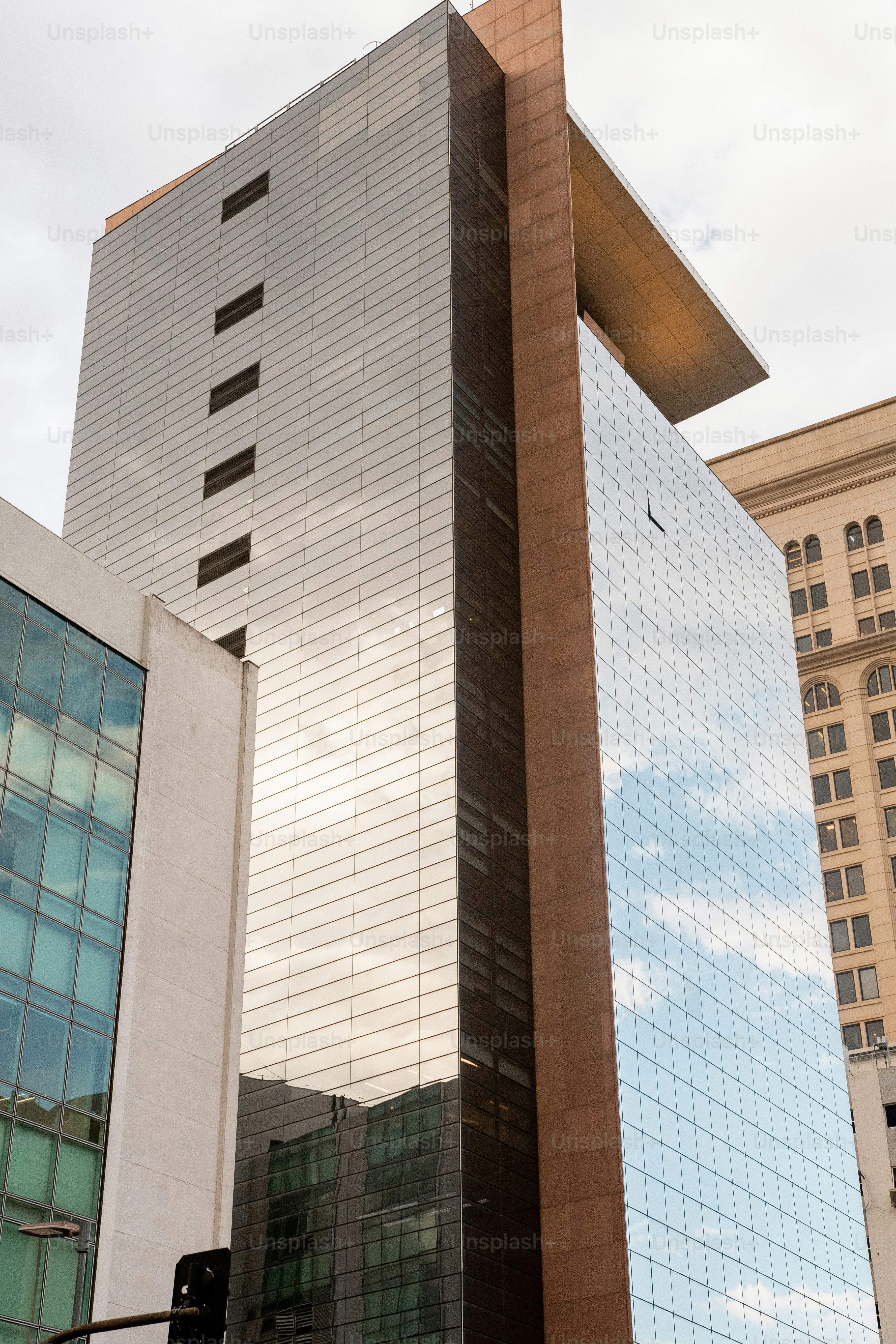 A tall building sitting next to a traffic light photo – Exterior Image ...