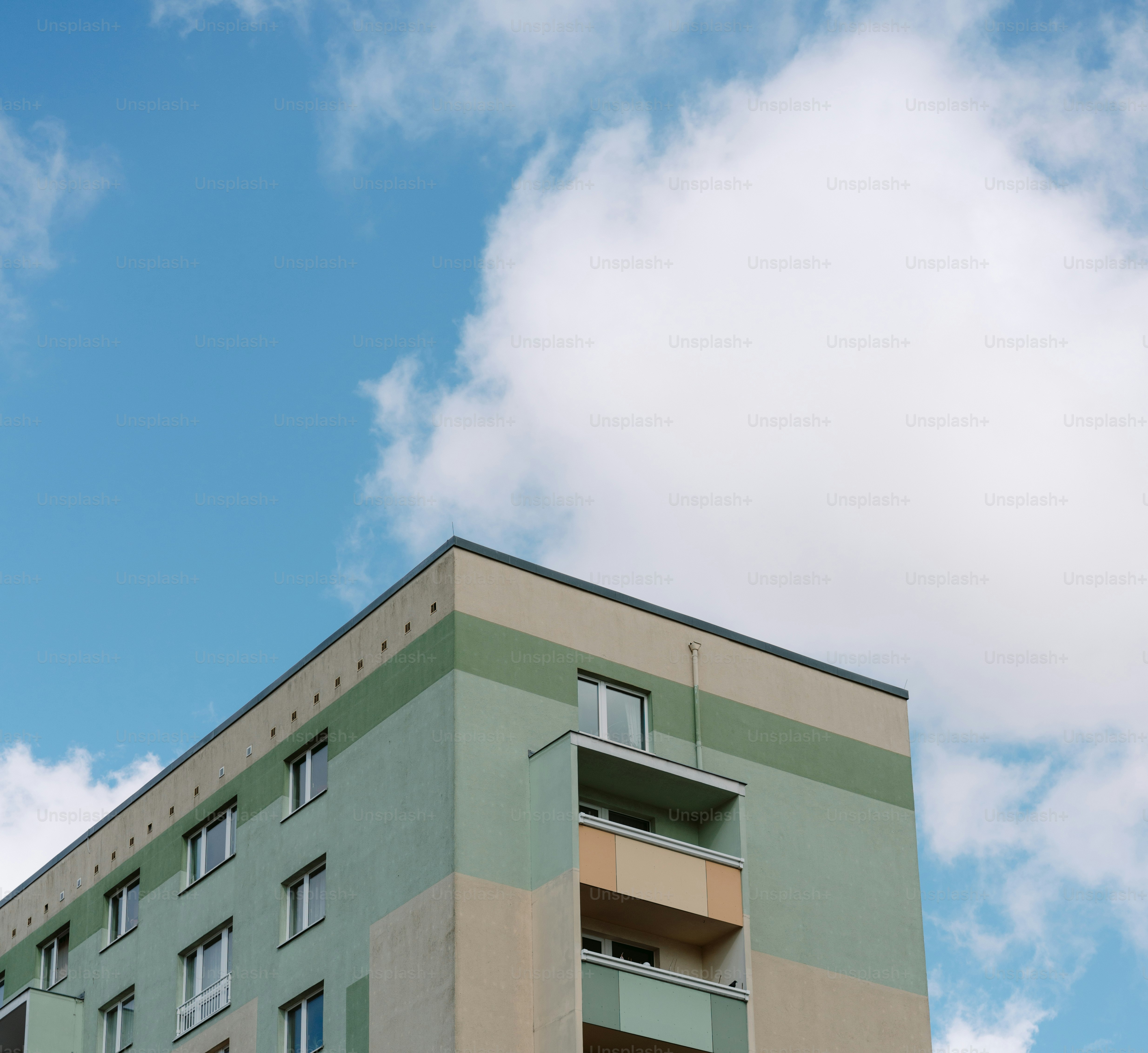 a tall building with balconies on the top of it