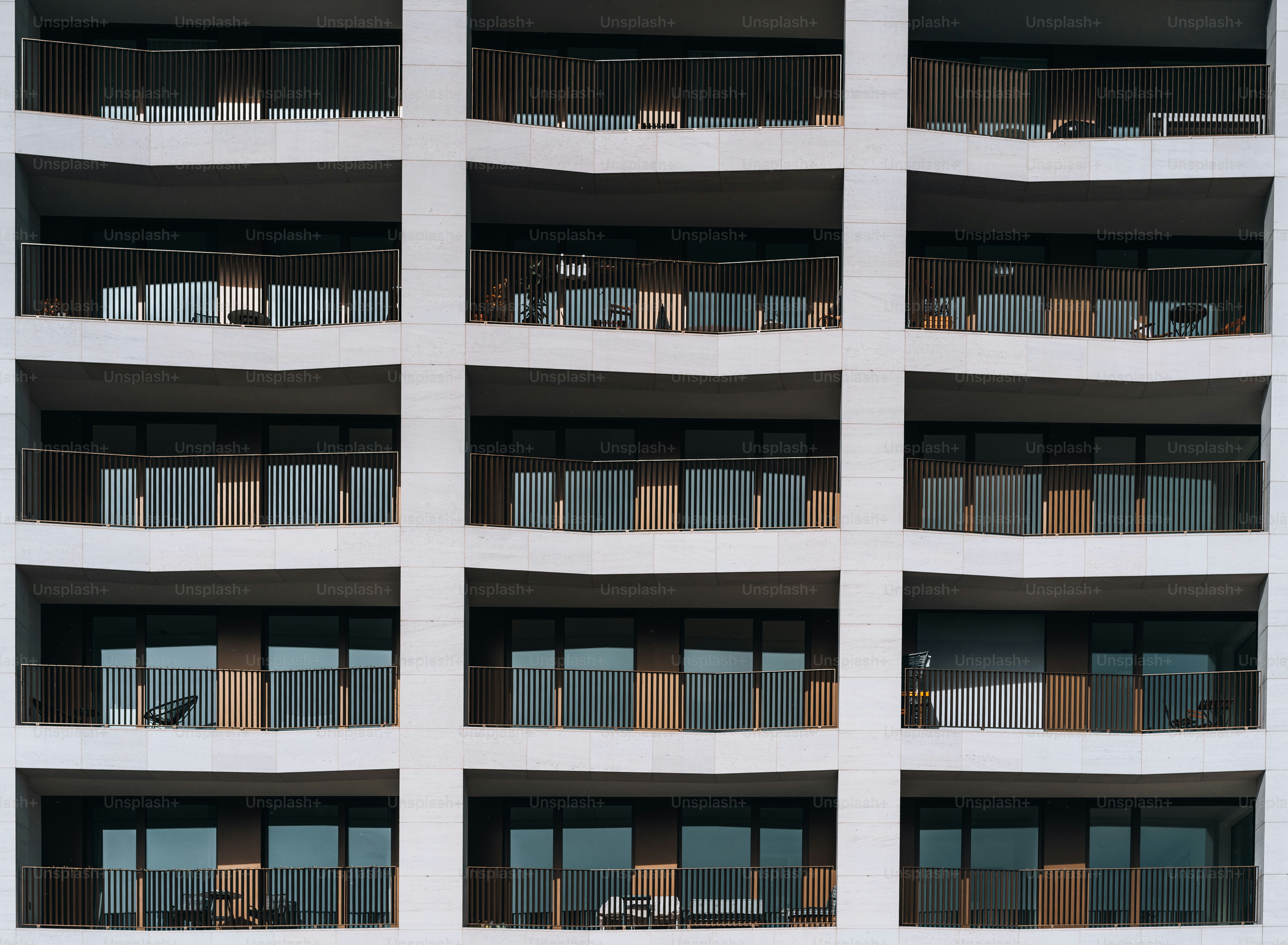 a tall white building with balconies and balconies