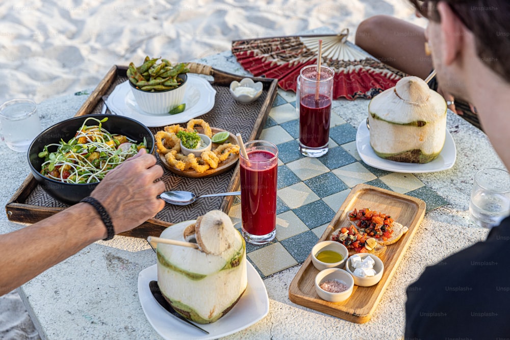 a man sitting at a table with food on it