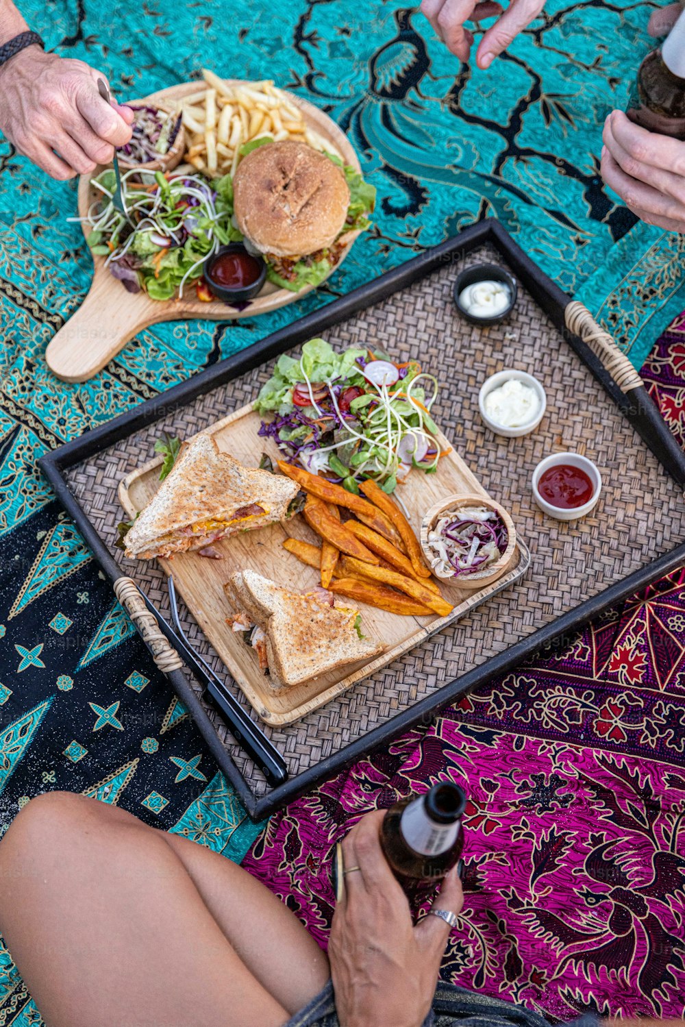 a woman sitting on the ground with a tray of food