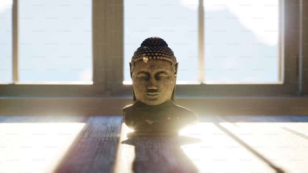 a buddha statue sitting on top of a wooden table