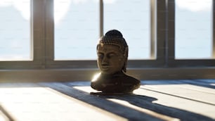 a buddha statue sitting on top of a wooden table