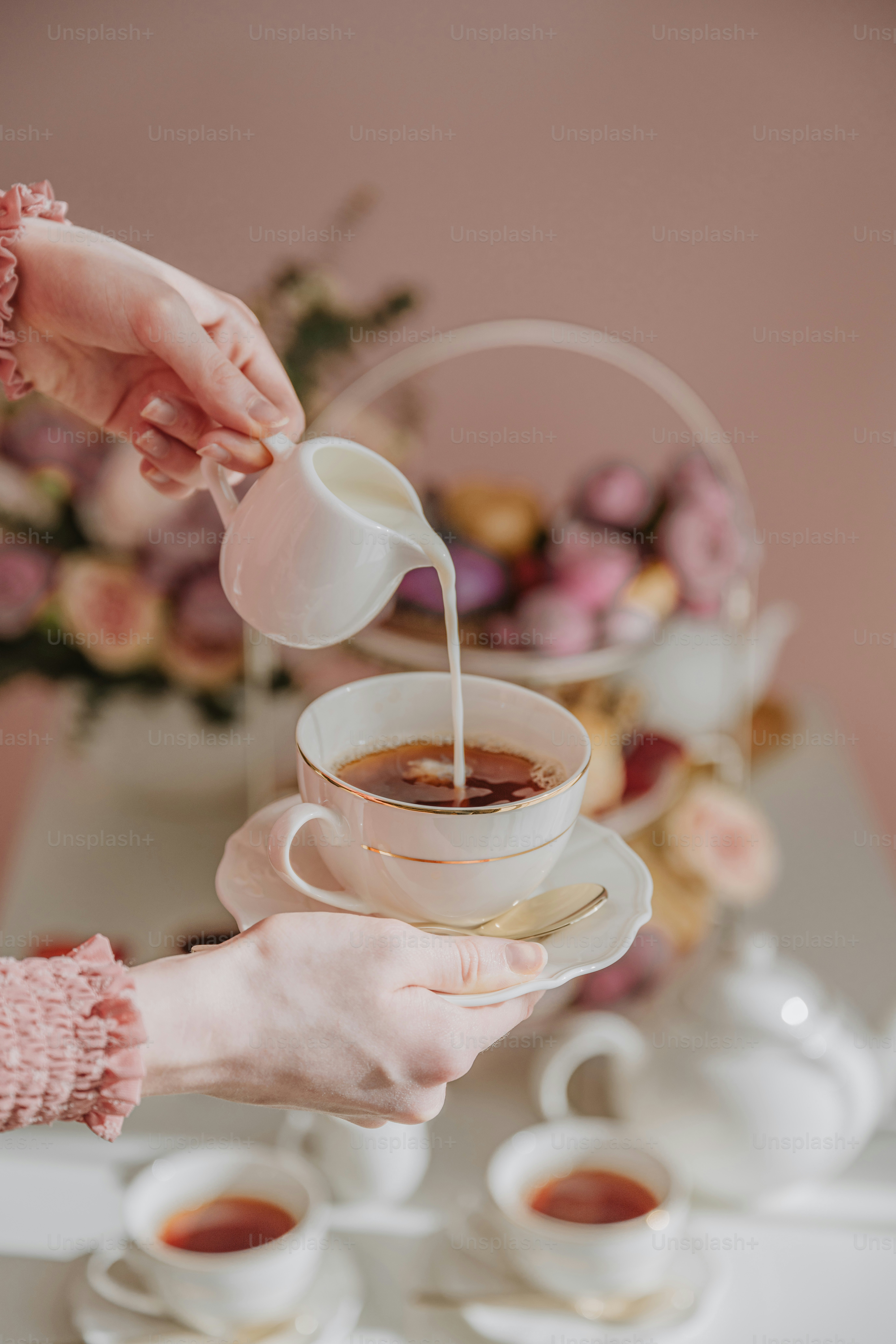 a cup of tea being poured into a cup