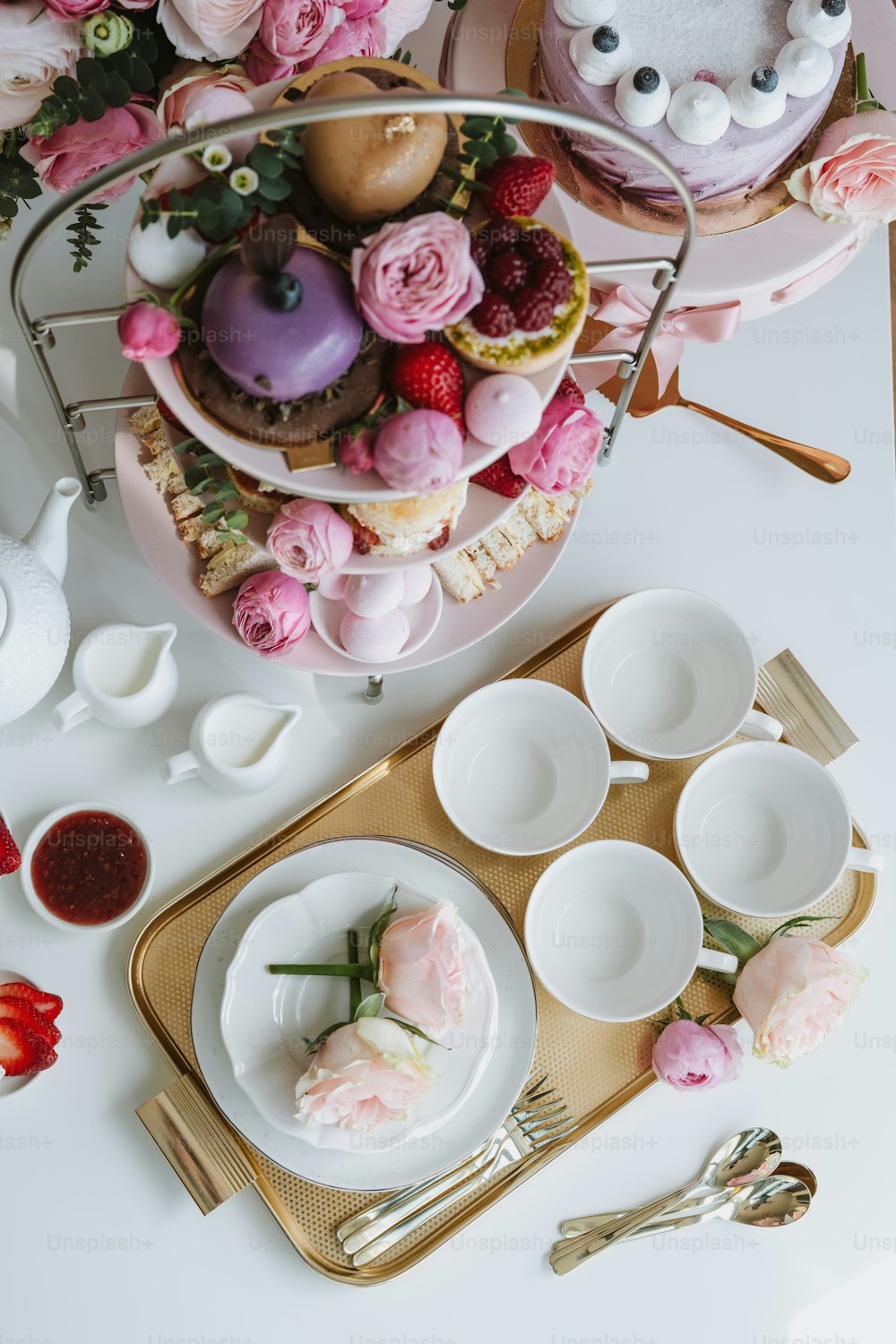 a table topped with plates and cups filled with food