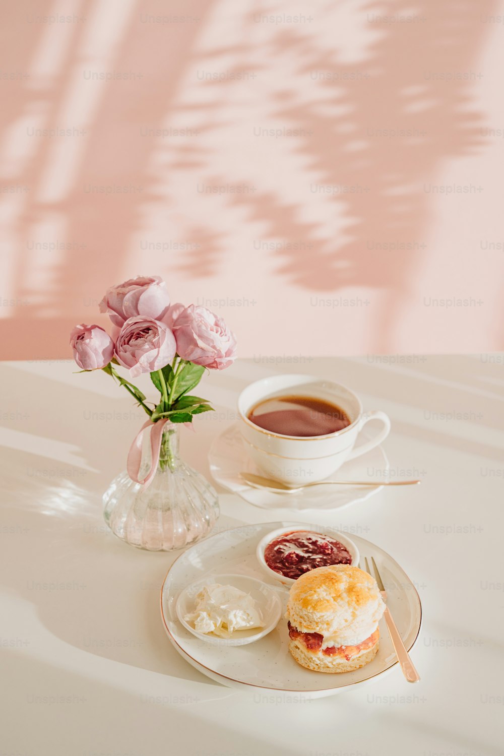 a cup of coffee and a plate of food on a table