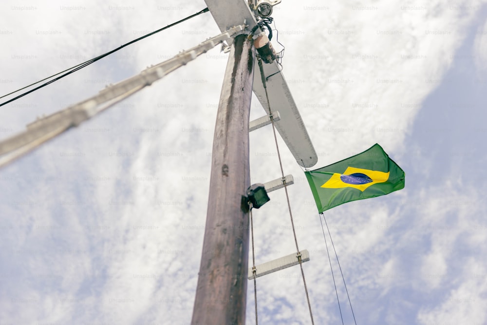 a green and yellow flag on a pole