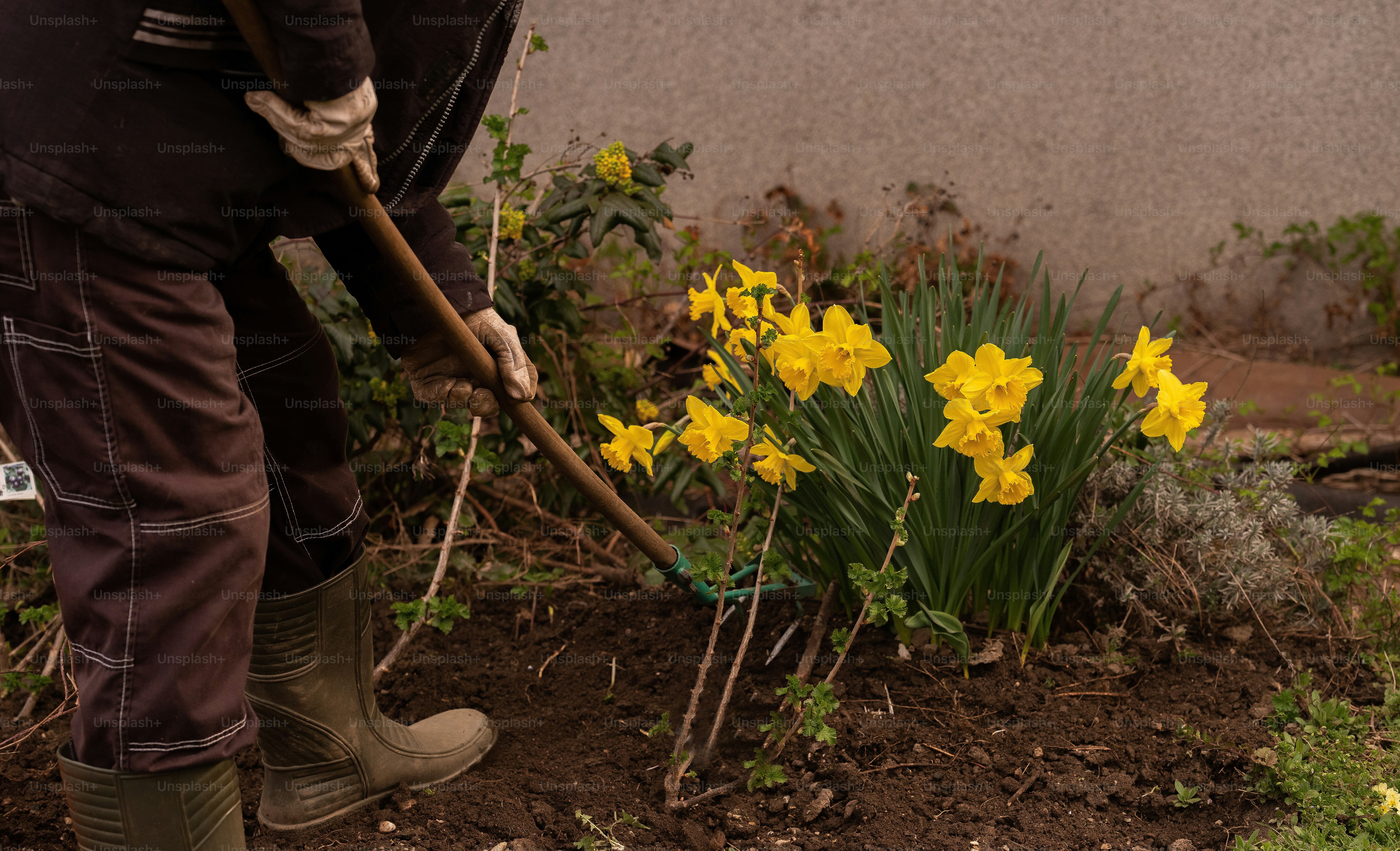 a man is digging in the dirt with a shovel
