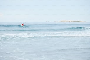 a person riding a surfboard on a wave in the ocean