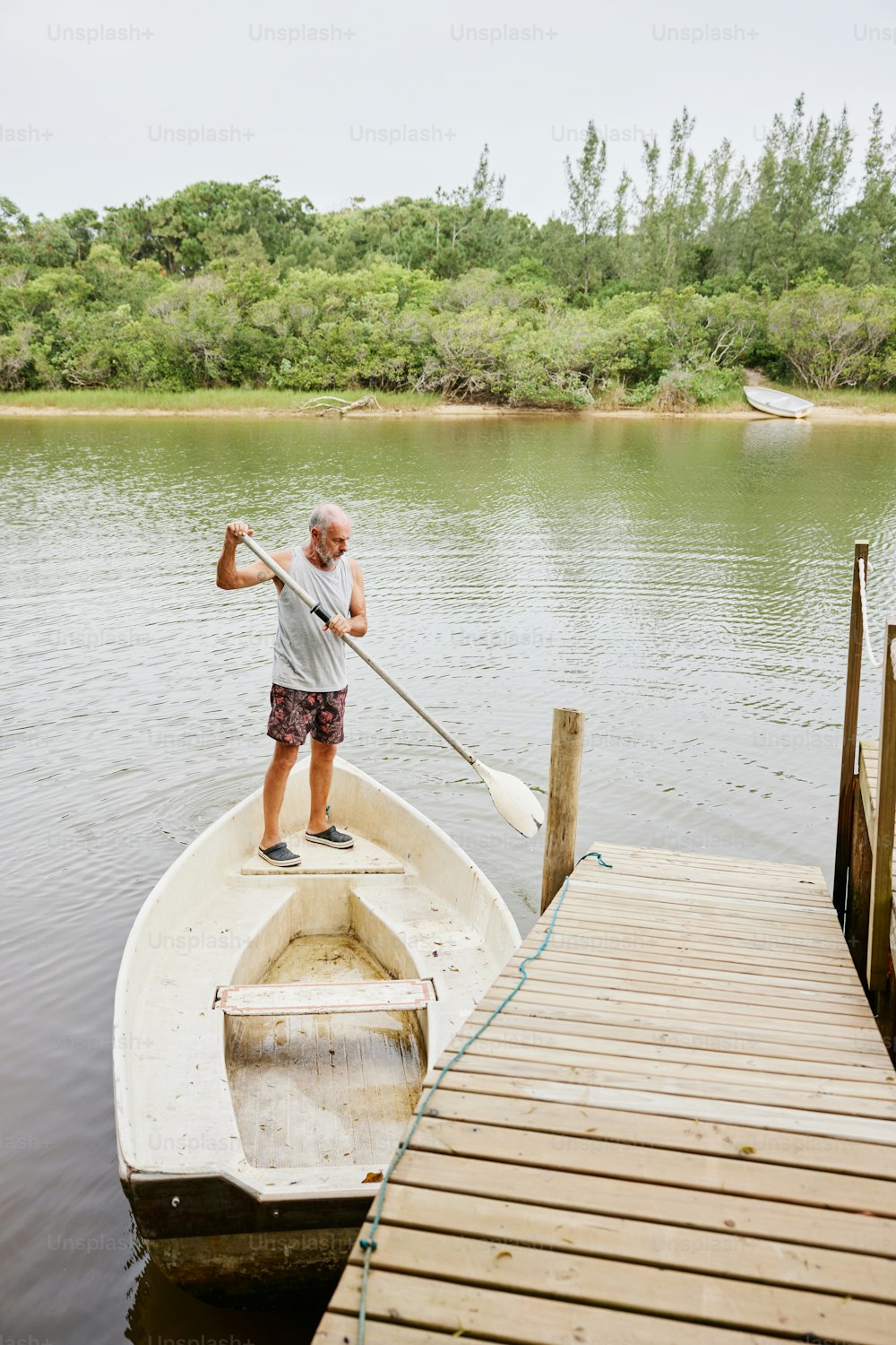 a man standing on a boat in the water