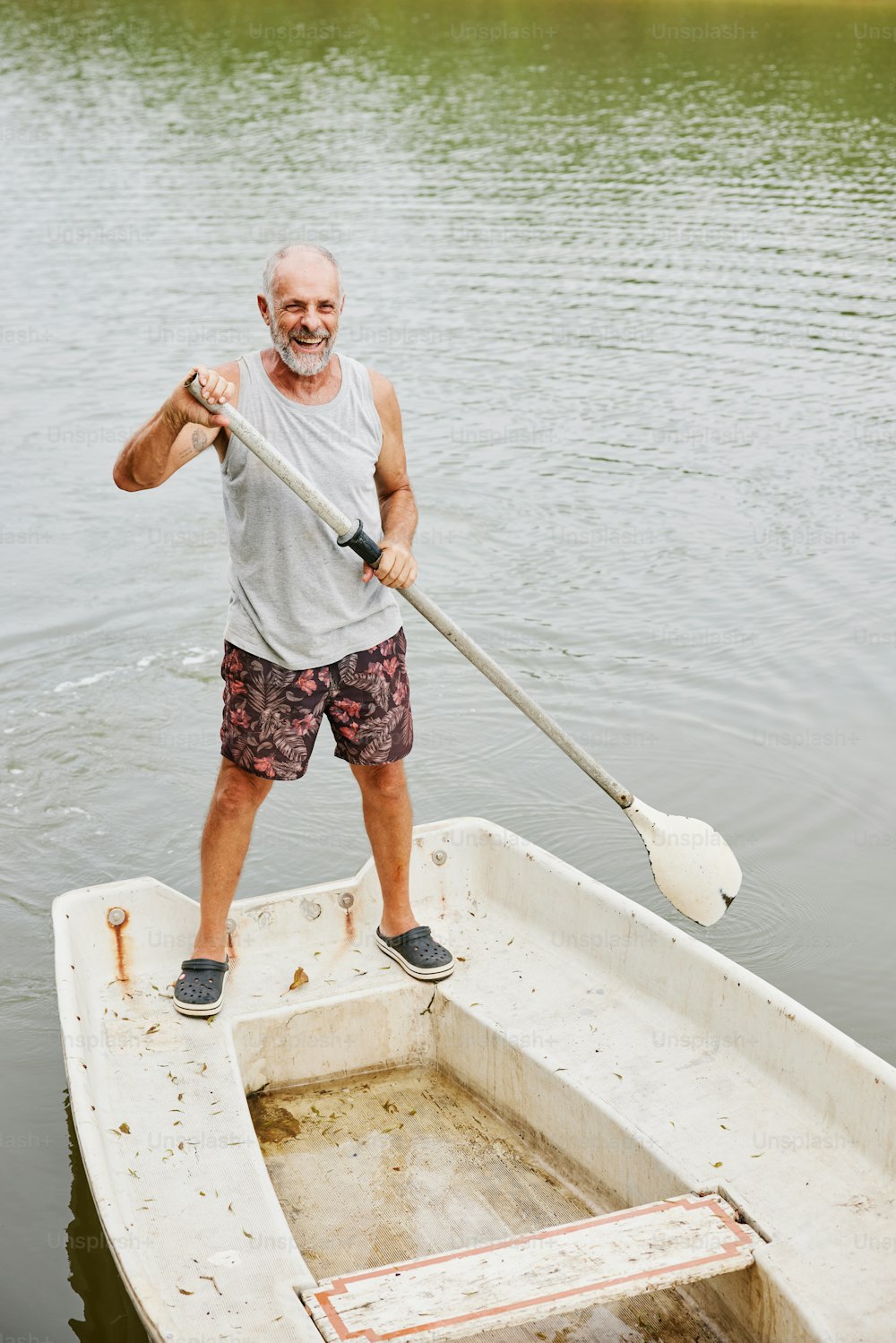 a man standing on a boat with a paddle