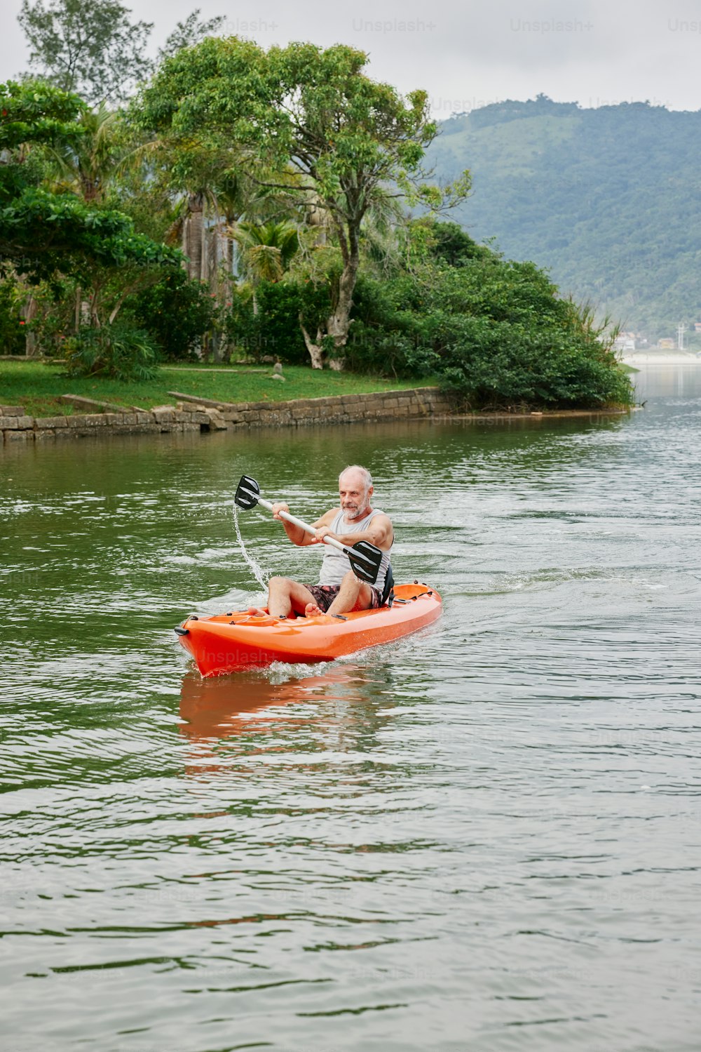 a man riding a kayak on top of a lake