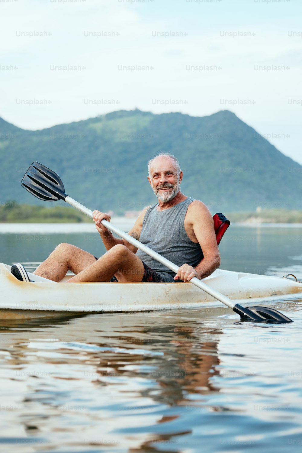 a man sitting in a kayak on a lake