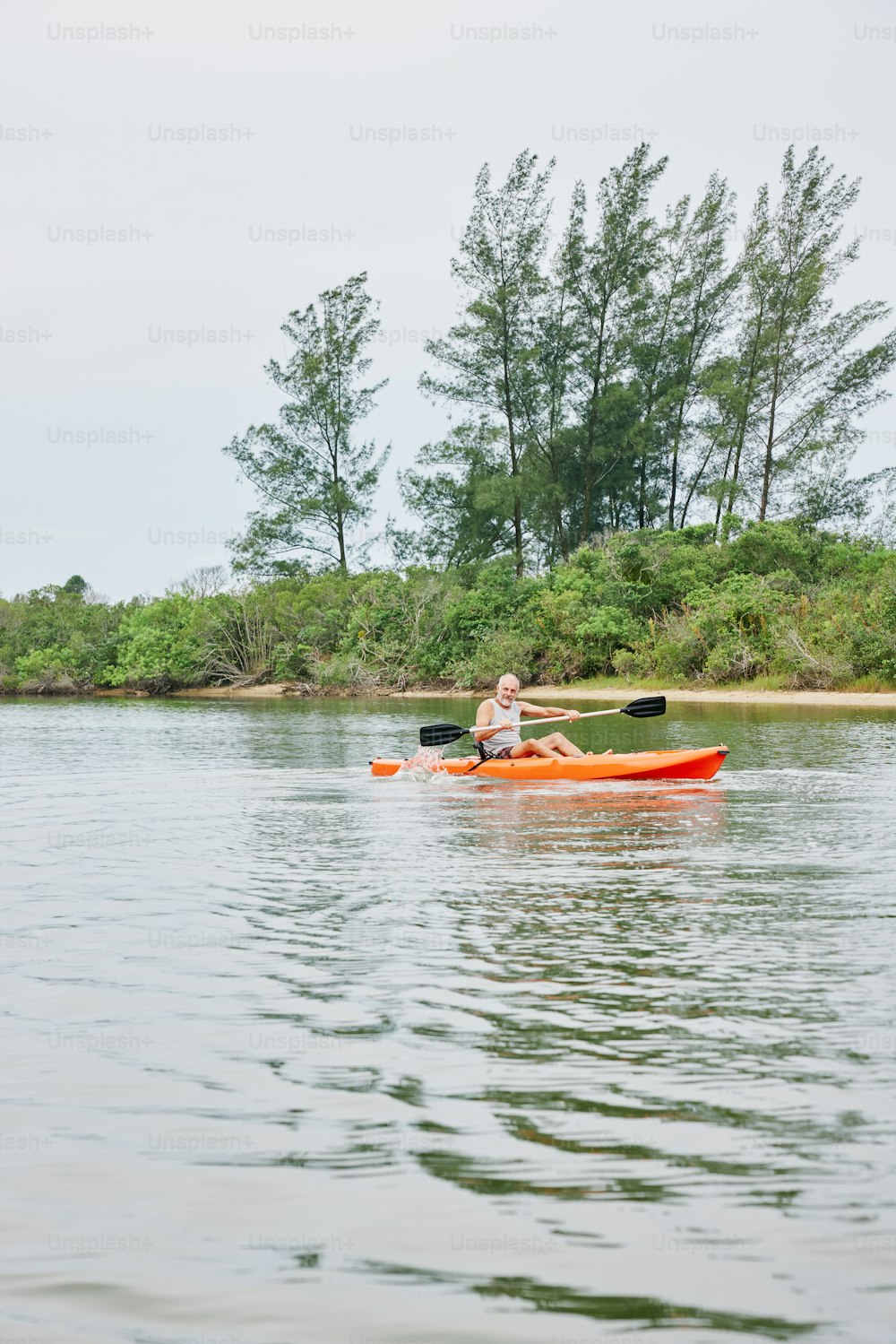 a woman is paddling a kayak on the water