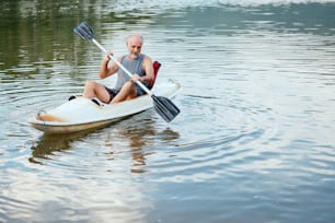 a man rowing a canoe on a lake