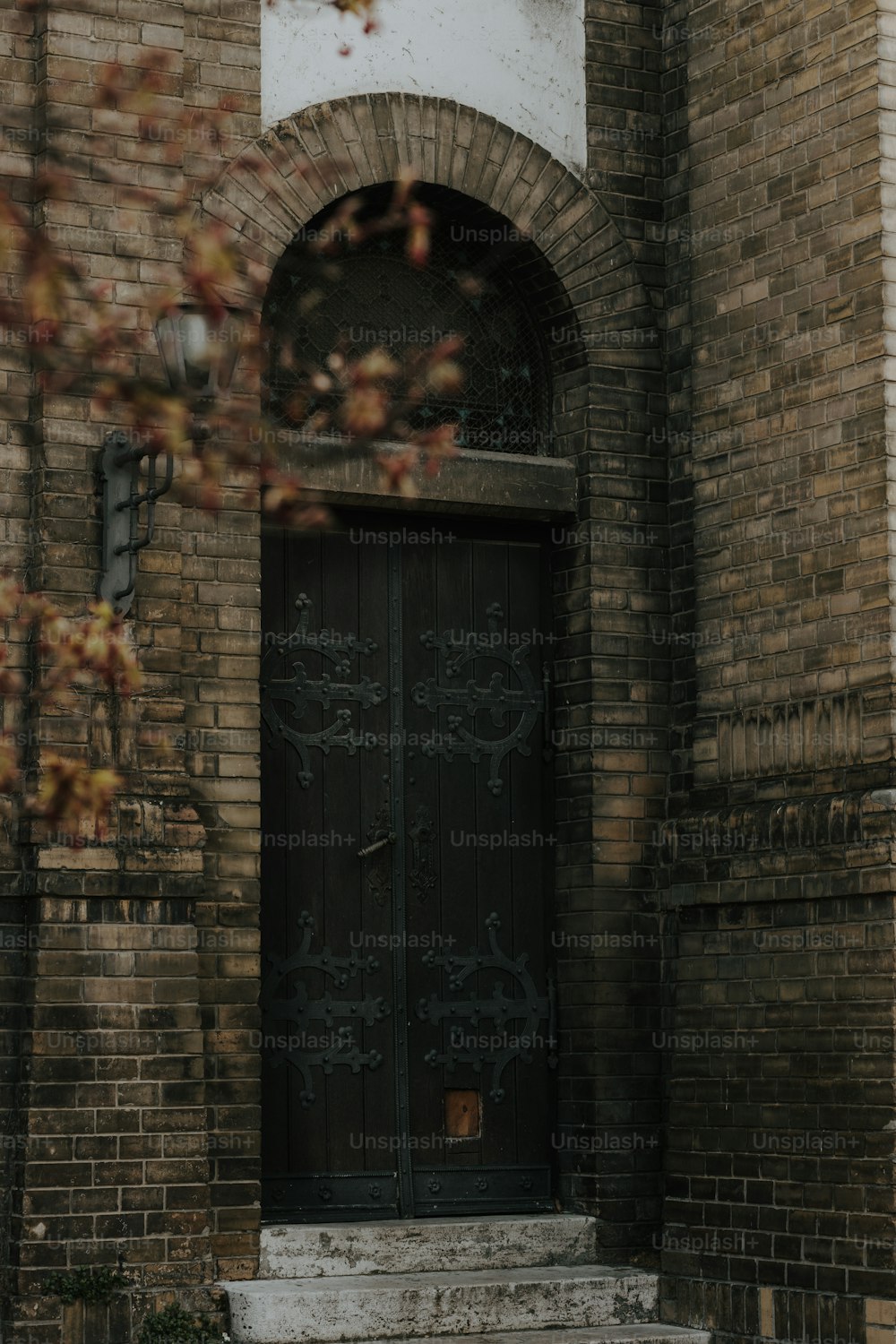 a black door with a clock on the side of it