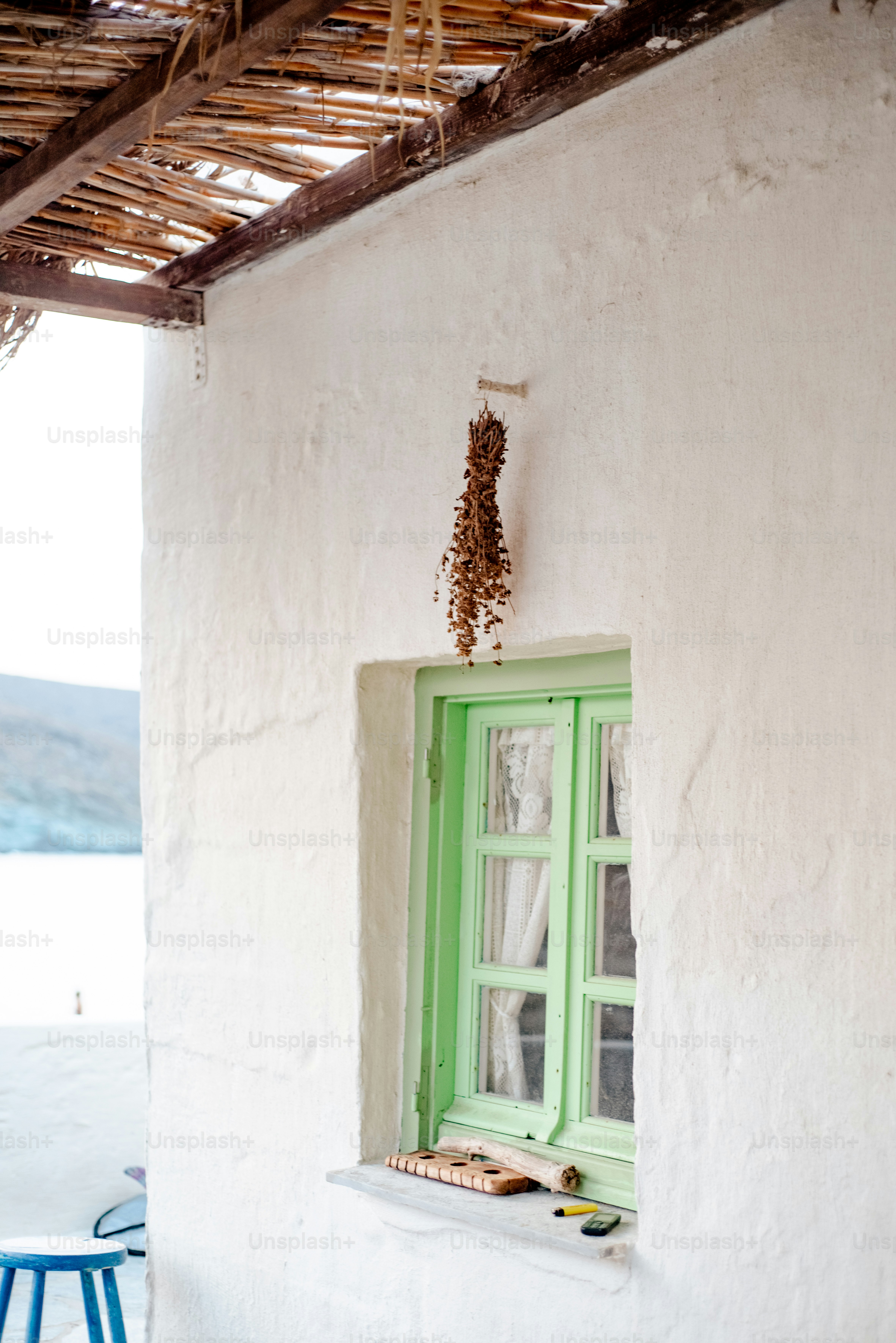 a green window in a white building
