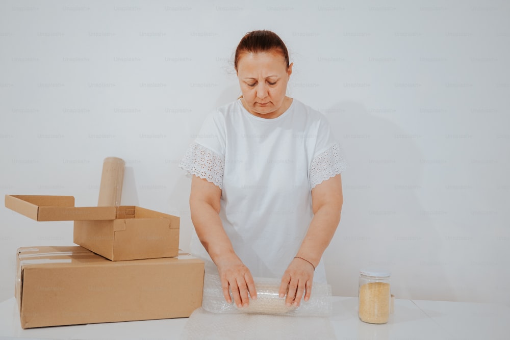 a woman in a white shirt and some boxes