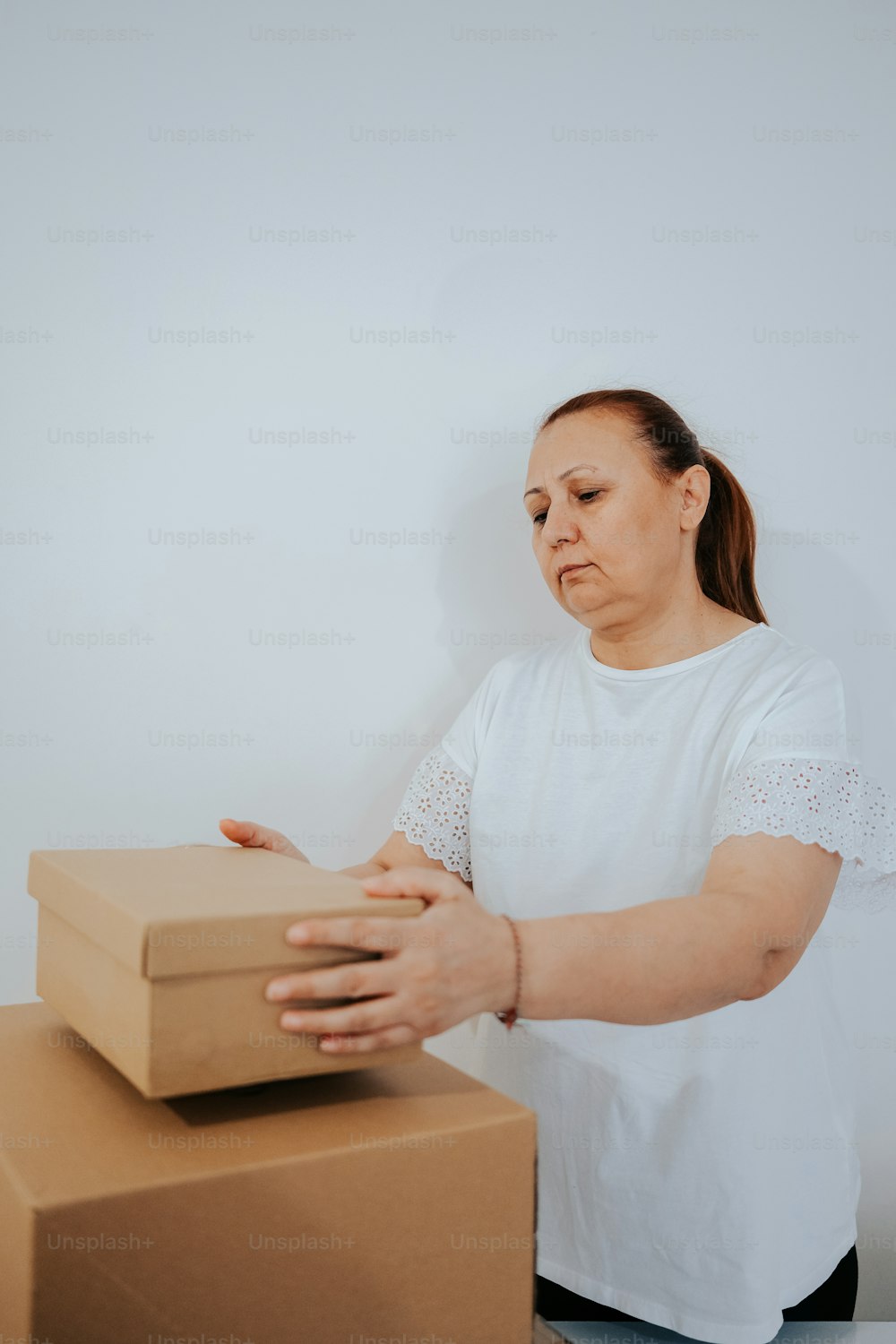 a woman standing next to a stack of boxes