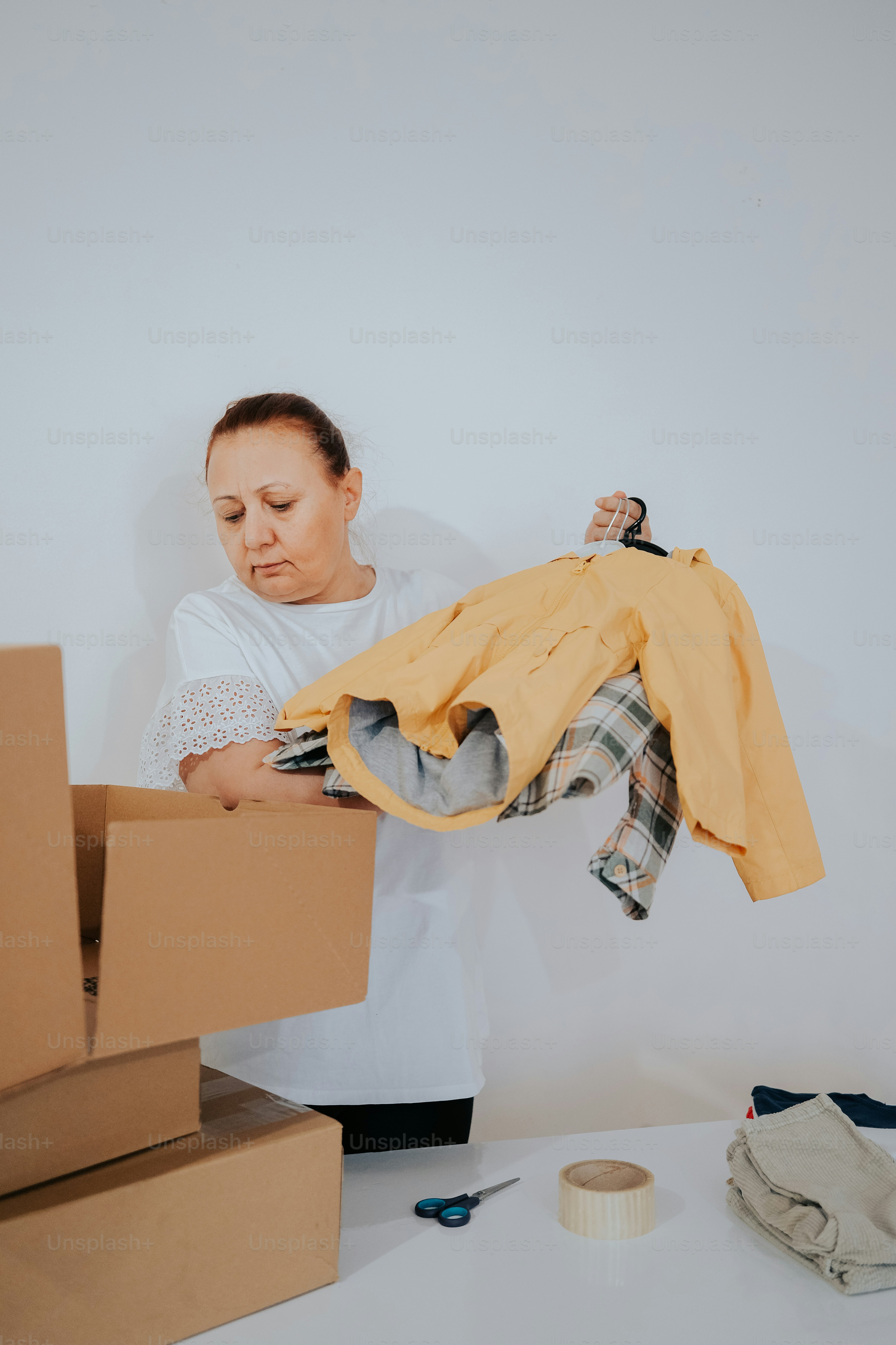 a woman in a white shirt is holding a banana