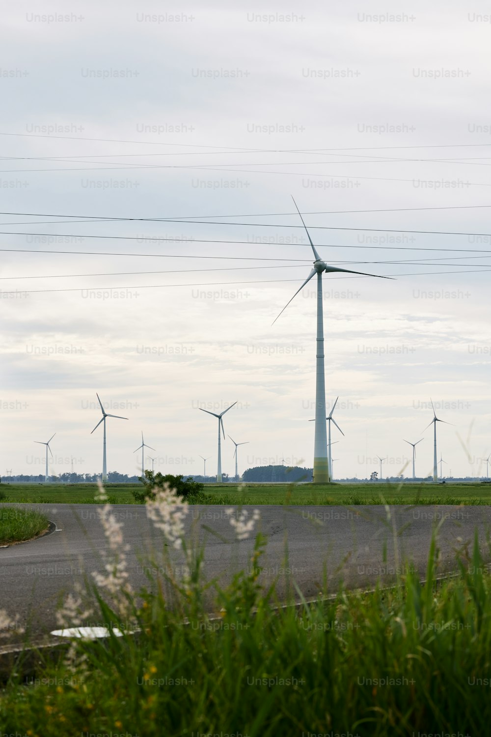 a wind farm with wind turbines in the background