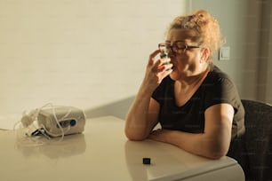 a woman sitting at a table taking a picture of herself