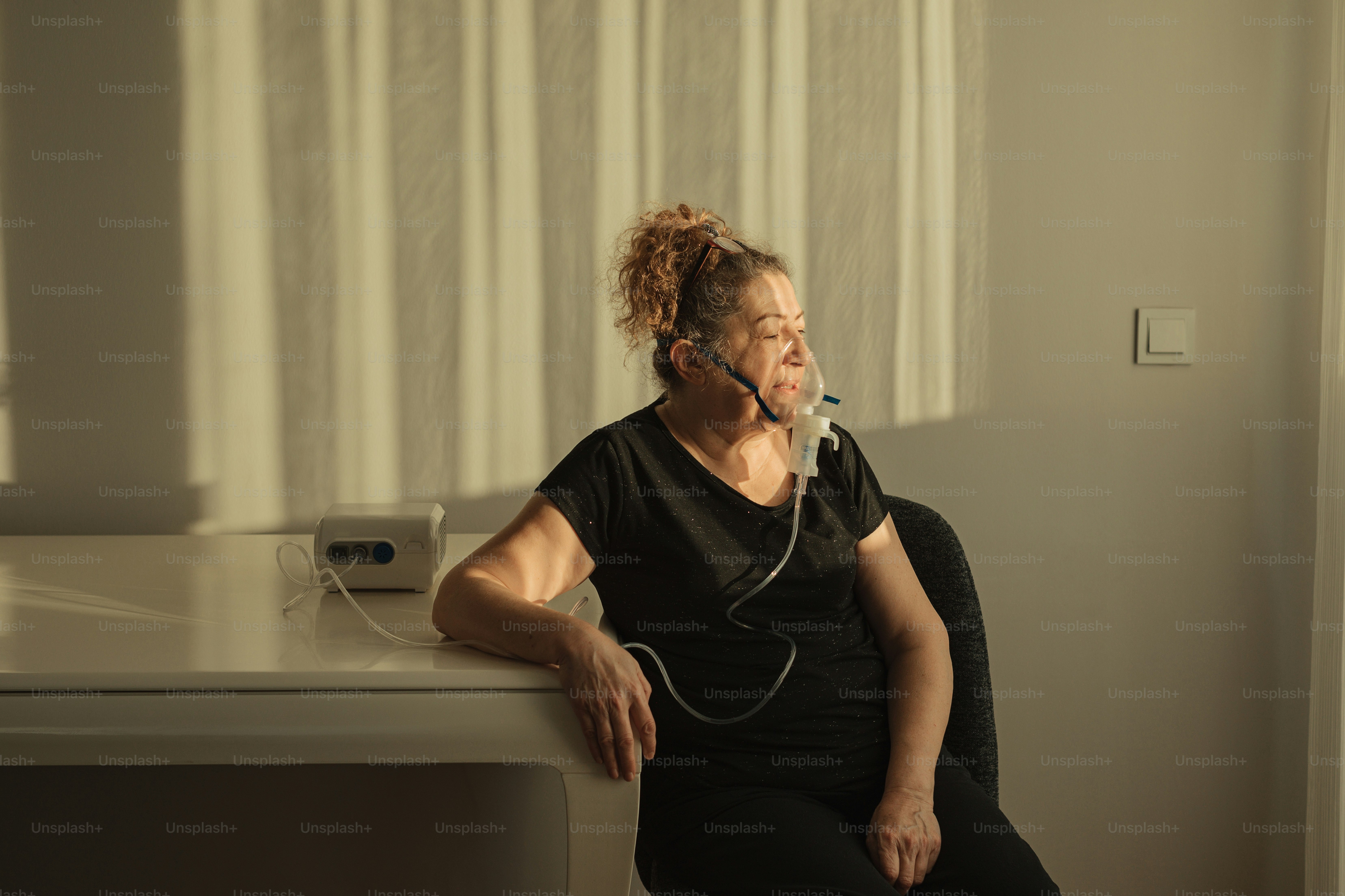 a woman sitting at a table with a cell phone in her ear
