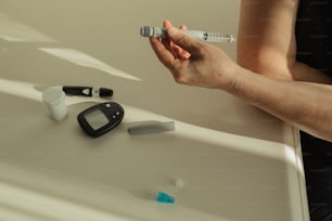 a woman is holding a thermometer next to a sink