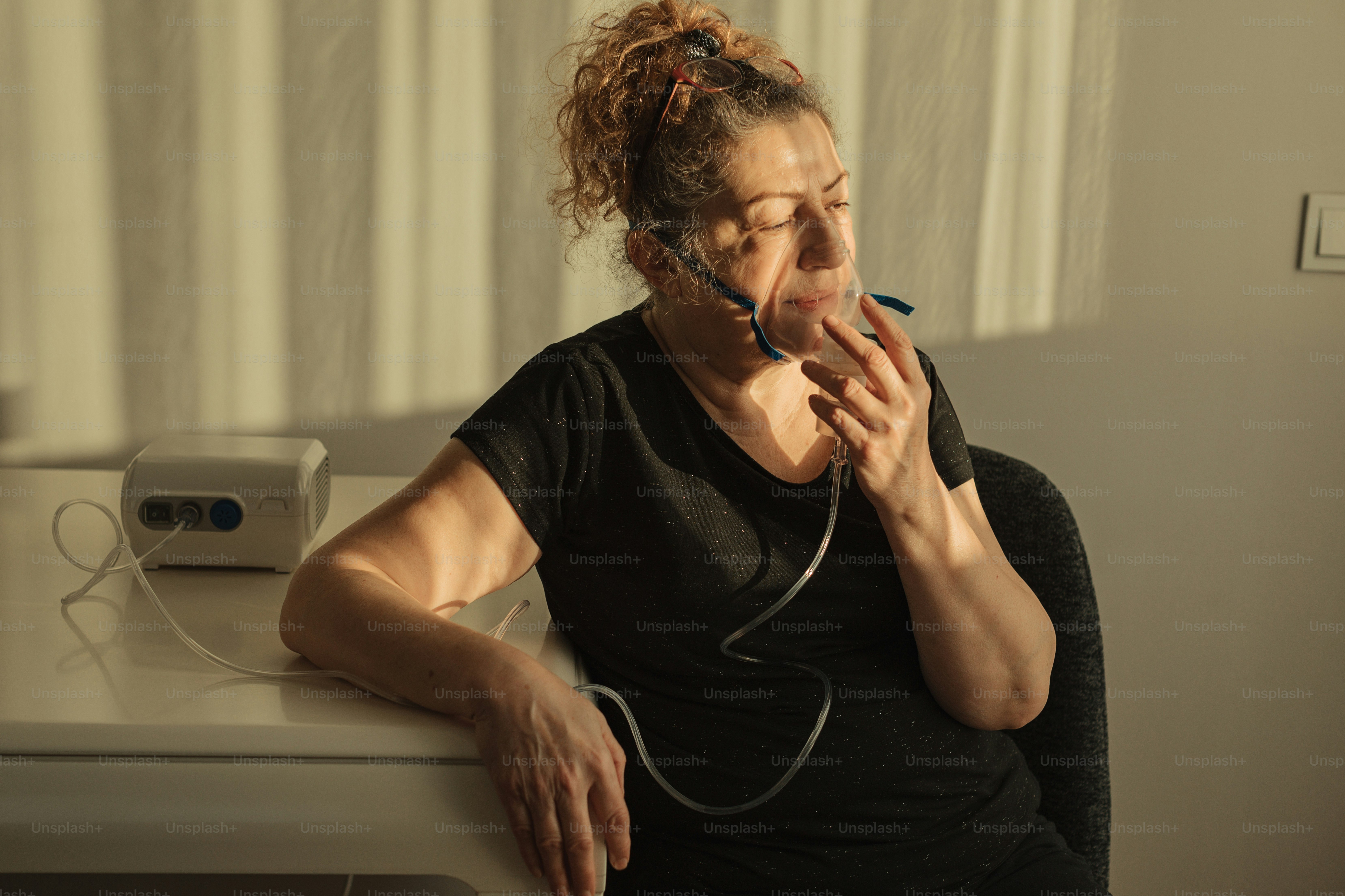 Una donna seduta a una scrivania che fuma una sigaretta