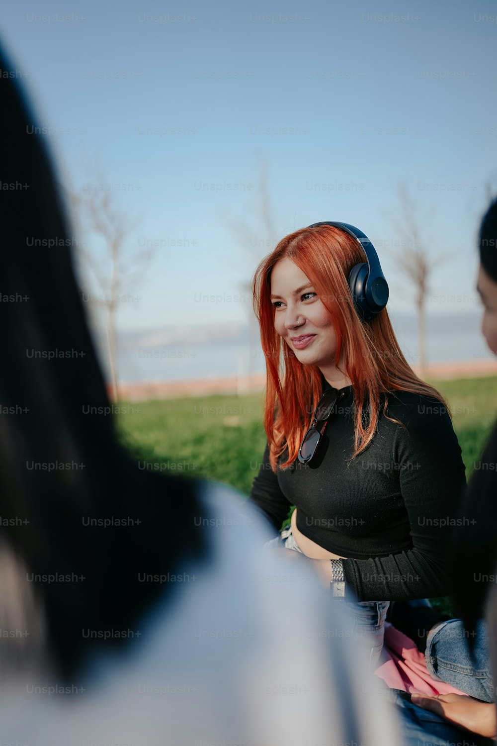 a woman with red hair wearing headphones