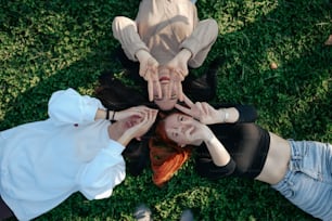 a group of people standing in a circle with their hands together