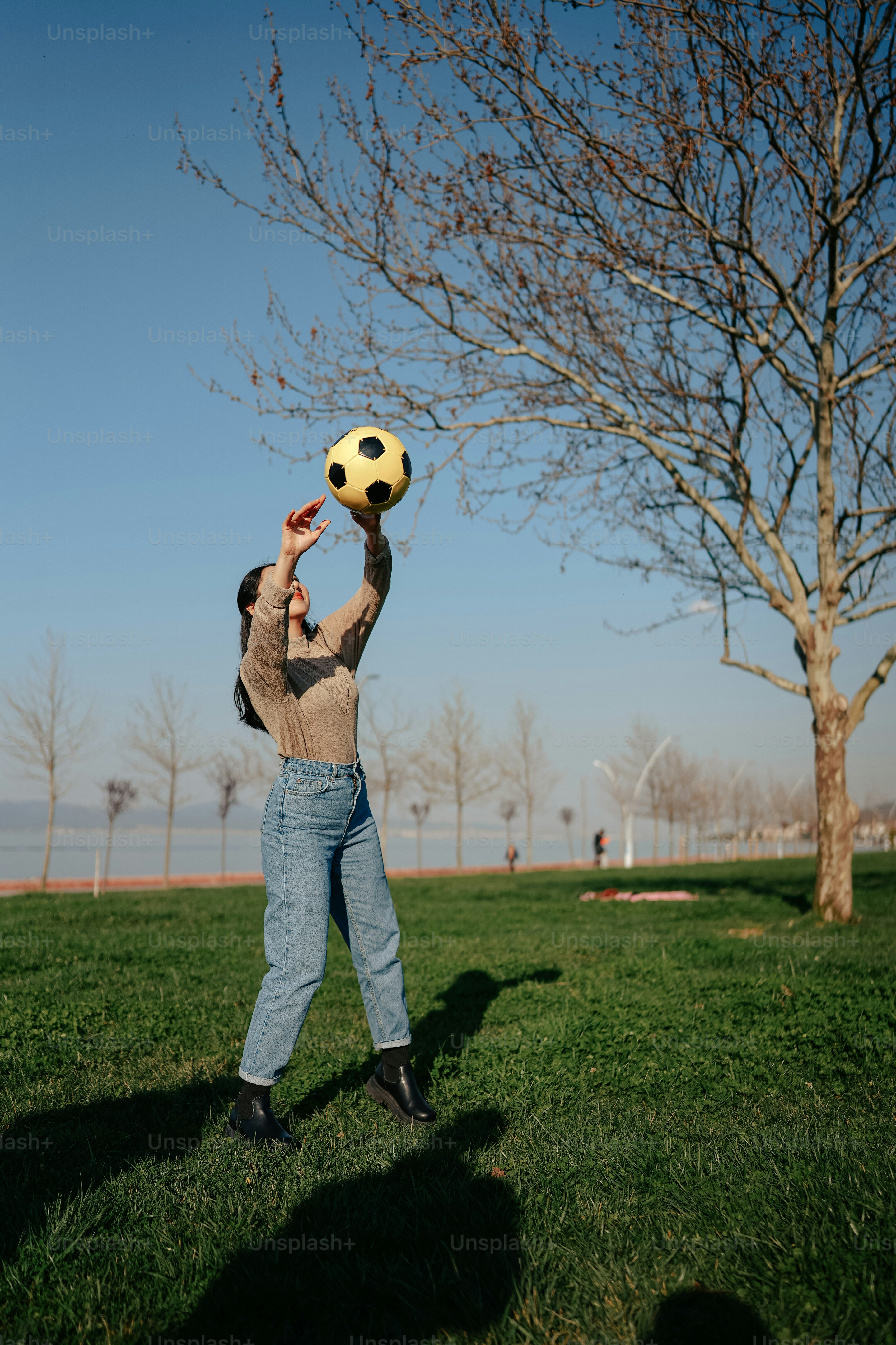 a man holding a yellow soccer ball in his hands