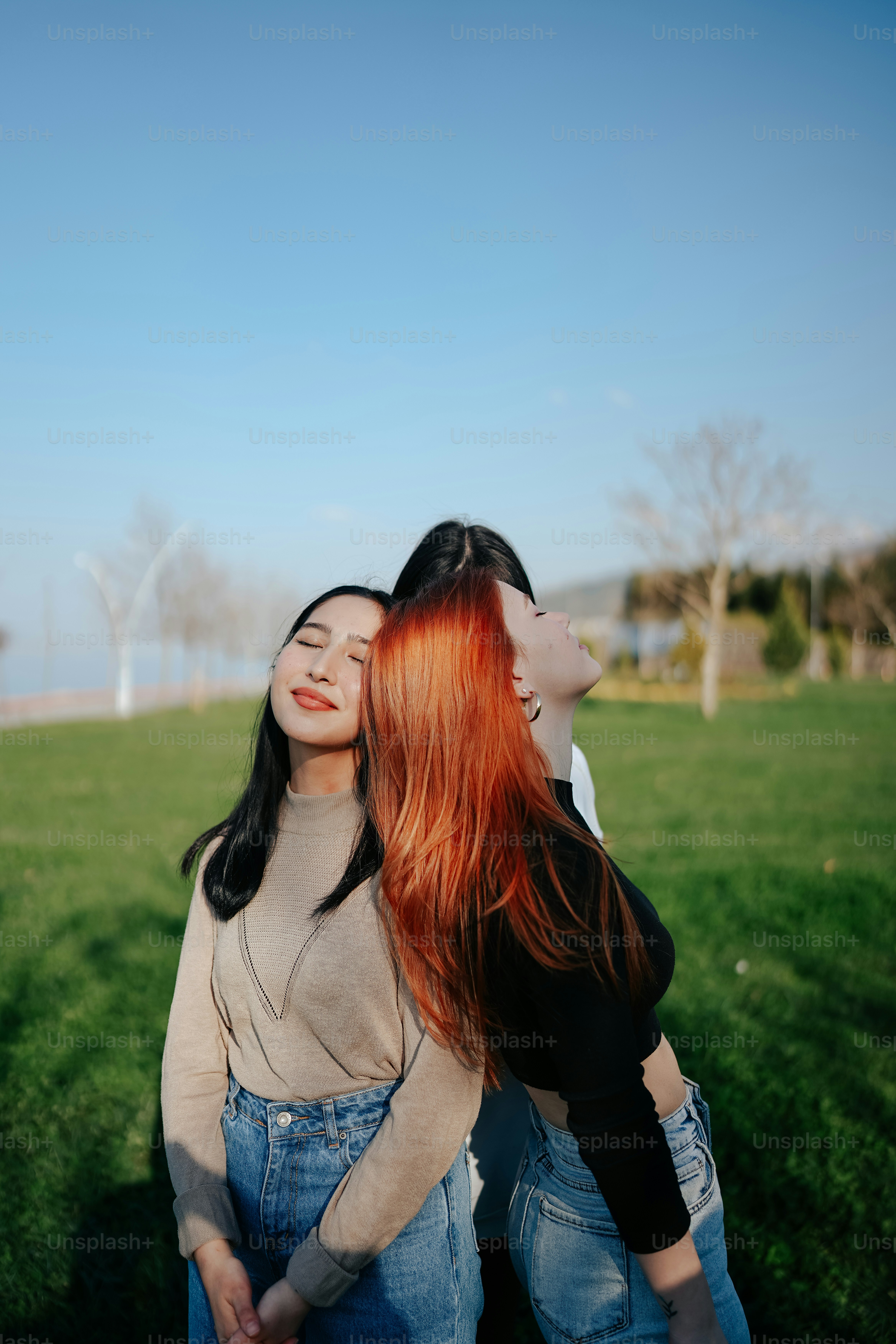 two women hugging each other in a field