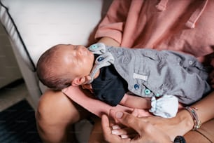 a woman holding a baby in her lap