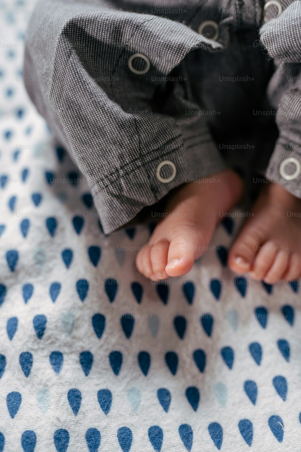 un primer plano de los pies de un bebé sobre una manta
