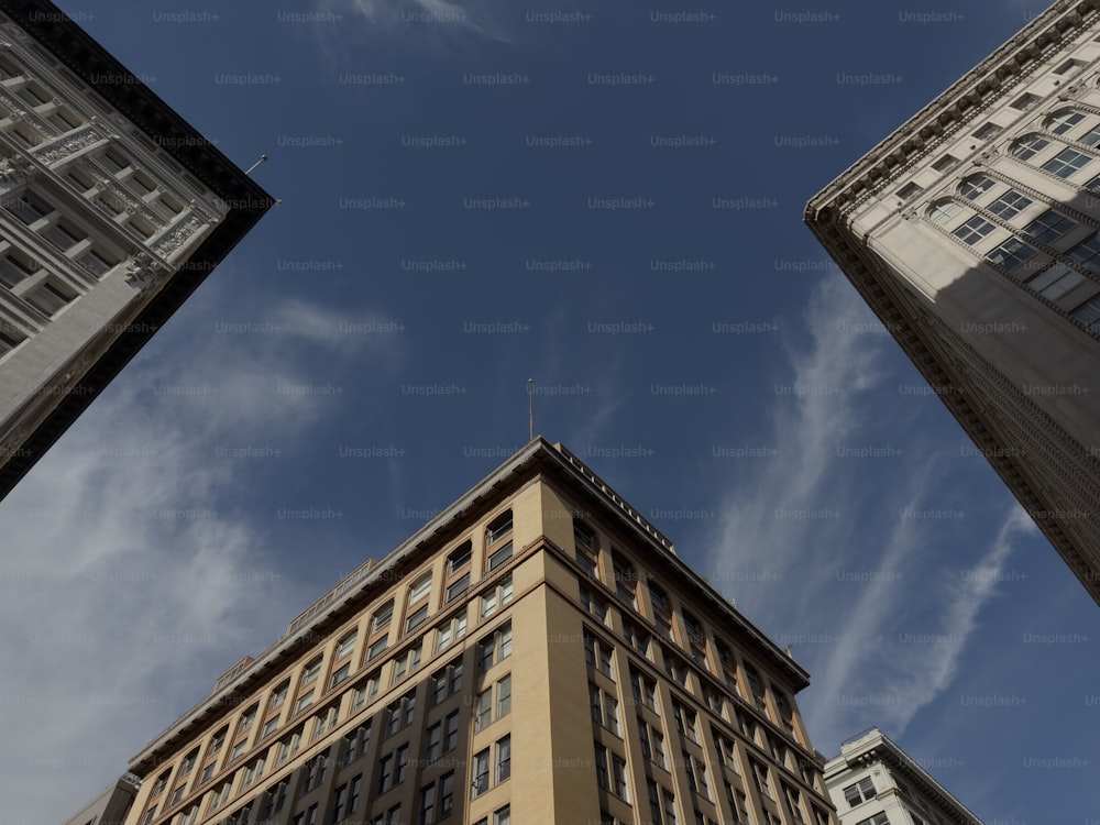 looking up at tall buildings in a city