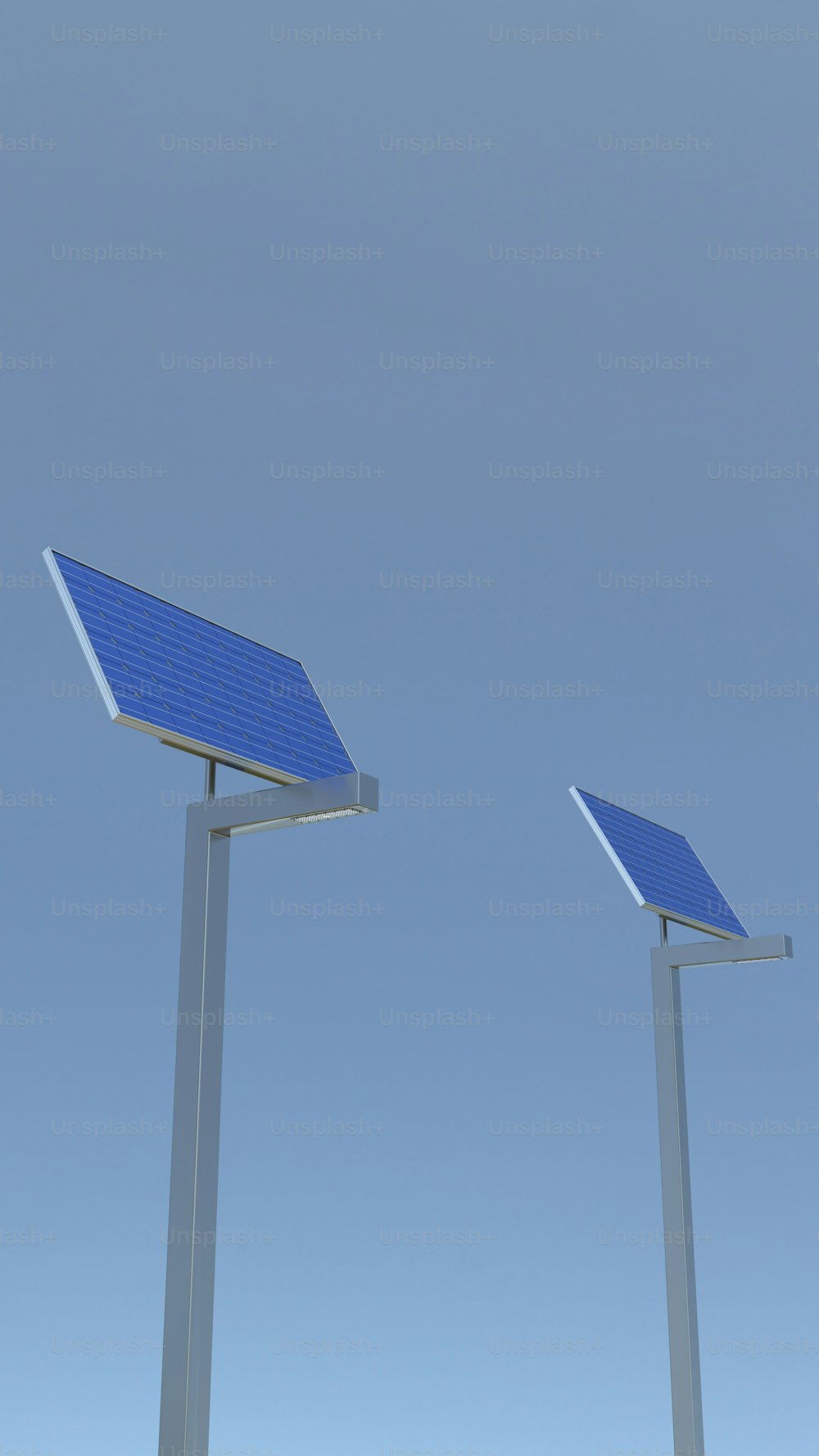 two solar panels on poles against a blue sky