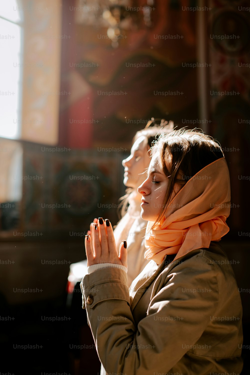 a woman with her hands together in prayer