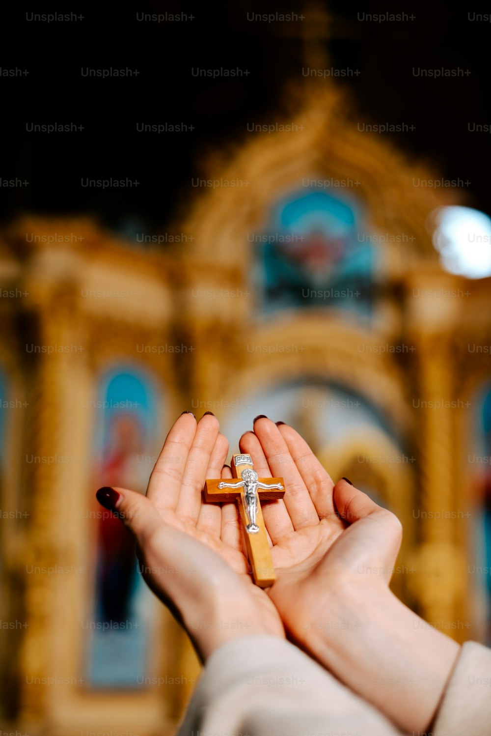 une personne tenant une croix dans ses mains