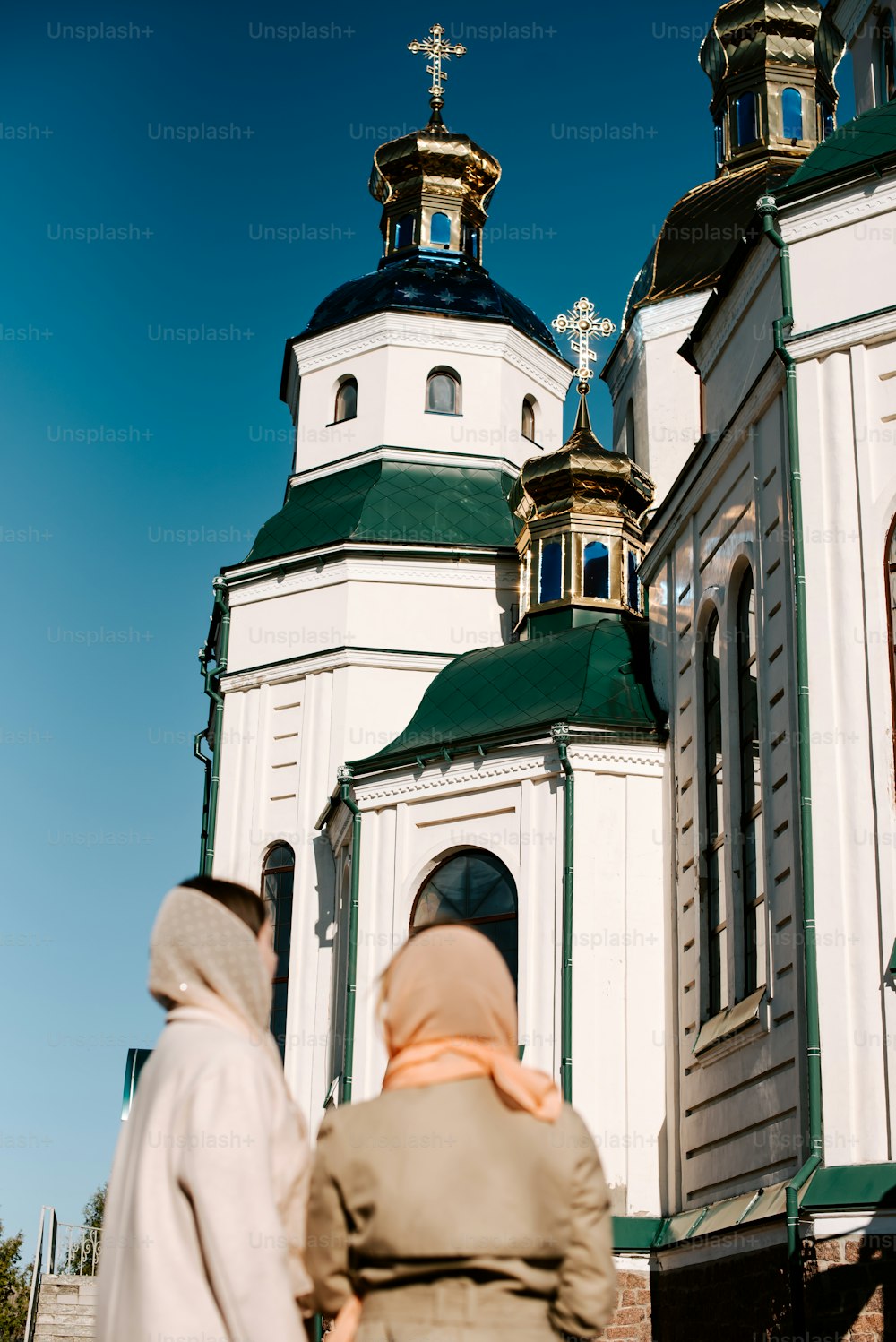 a man and a woman walking in front of a church