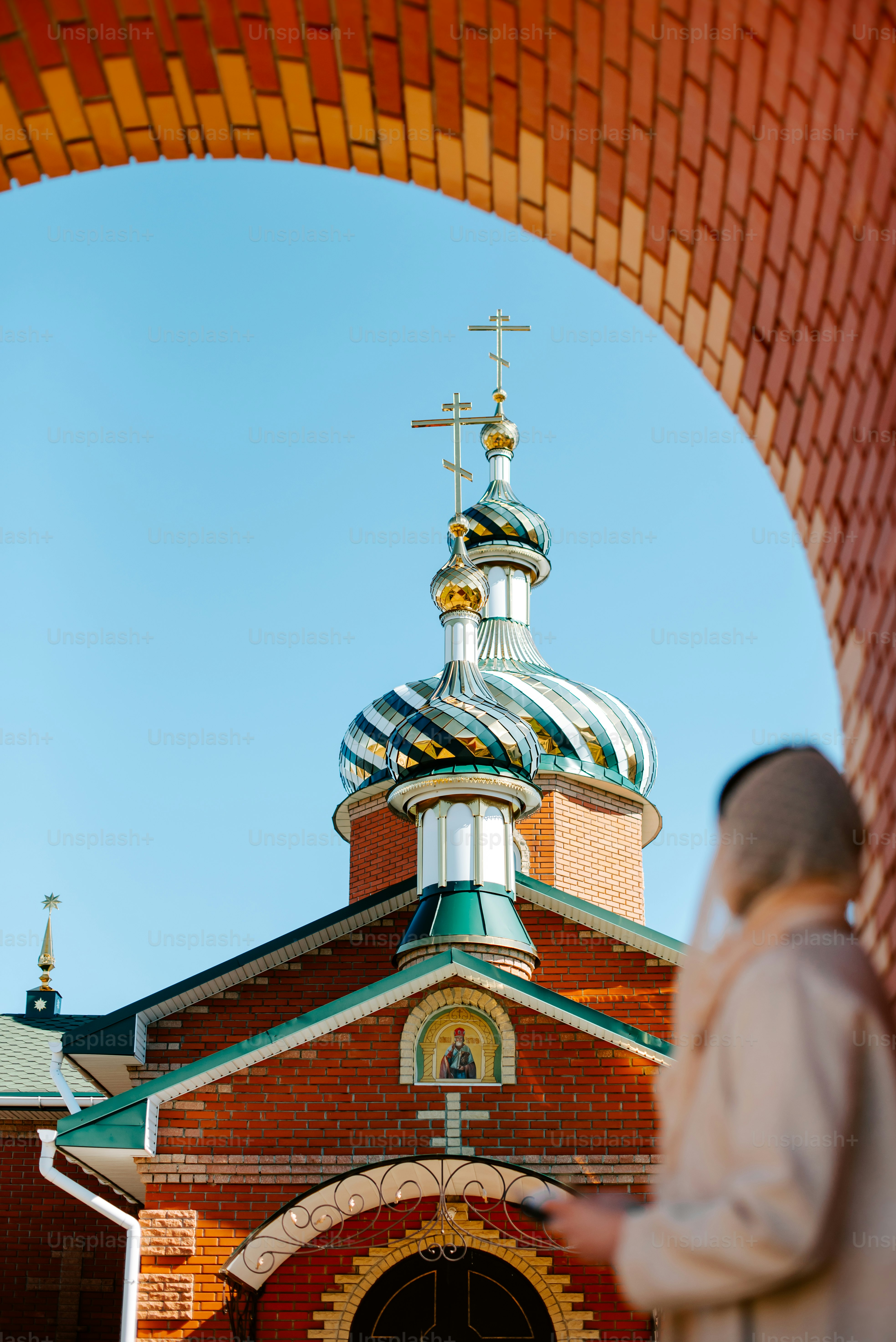 a man standing in front of a building with a cross on it