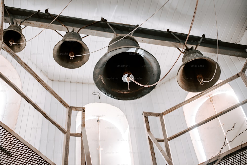 a group of bells hanging from the ceiling